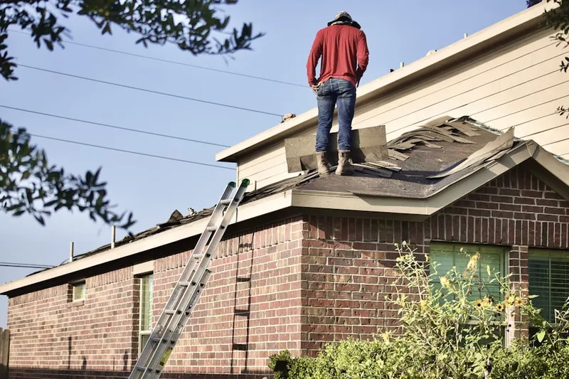 Professional roofer working on a residential roof in Rose Village